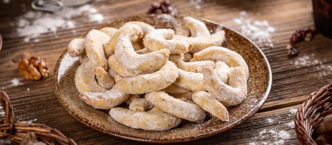 Crescent shaped Christmas cookies with wallnut and icing sugar
